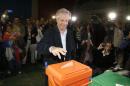 Presidential candidate for the ruling Frente Amplio party Tabare Vazquez casts his vote in a polling station in Montevideo