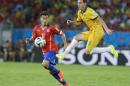 Australia's Mark Milligan (5) kicks the ball past Chile's Eduardo Vargas (11) during the second half of the group B World Cup soccer match between Chile and Australia in the Arena Pantanal in Cuiaba, Brazil, Friday, June 13, 2014. (AP Photo/Thanassis Stavrakis)