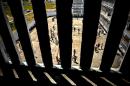 Cuban inmates are seen through bars at a maximum security prison, in Havana, on April 9, 2013