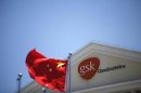 A Chinese national flag flutters in front of a GlaxoSmithKline (GSK) office building in Shanghai