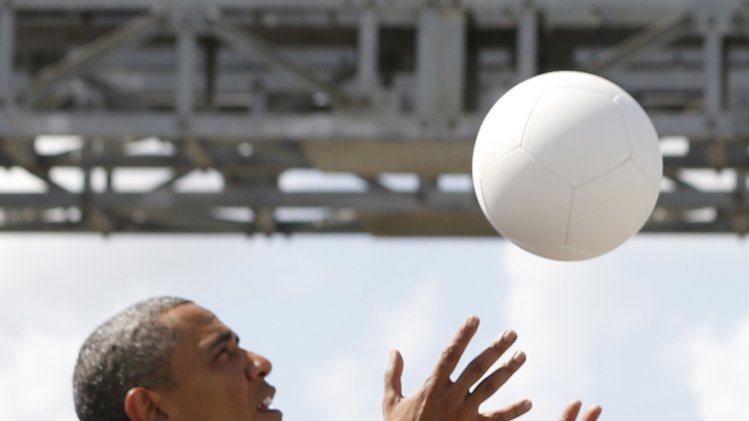 U.S. President Obama plays with a soccer ball during a demonstration at the Ubungo Power Plant in Dar es Salaam