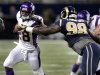 Minnesota Vikings running back Adrian Peterson, left, runs for a 13-yard gain as St. Louis Rams defensive tackle Kendall Langford defends during the second quarter of an NFL football game Sunday, Dec. 16, 2012, in St. Louis. (AP Photo/Tom Gannam)