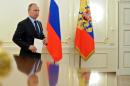 Russia's President Vladimir Putin attends a meeting with his envoys to the Federal Districts in the Novo-Ogaryovo state residence outside Moscow on April 9, 2014