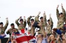 British soldiers cheer during their men's preliminary round beach volleyball match between Britain and Brazilo at the London 2012 Olympic Games at Horse Guards Parade