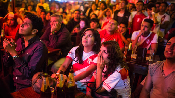 Fans of Peru&#39;s national soccer team watch dejectedly on television as their team loses to Chile during a semifinal Copa America match, in Lima, Peru, Monday, June 29, 2015. Chile won the match 2-1. (AP Photo/Sebastian Castañeda)