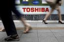 FILE PHOTO - Pedestrians walk past a logo of Toshiba Corp outside an electronics retailer in Tokyo