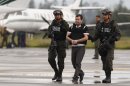 Major drug trafficking suspect, Daniel Barrera is escorted to a waiting car, prior to his extradition to the U.S., at the counter-narcotics base in Bogota, Colombia, Tuesday, July 9, 2013. Colombian President Juan Manuel Santos has called Barrera "the last of the great capos." He's known as 