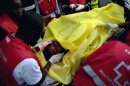 A victim of one of the attacks is wheeled by paramedics to a waiting ambulance