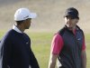 Rory McIlroy from Northern Ireland, rear, and Tiger Woods from U.S. talk on the 13th hole during the first round of Abu Dhabi Golf Championship in Abu Dhabi, United Arab Emirates, Thursday, Jan. 17, 2013. (AP Photo/Kamran Jebreili)