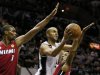 Spurs' Parker drives to the net between Heat's Bosh and Chalmers during Game 3 of their NBA Finals basketball playoff in San Antonio