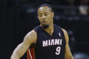 FILE-This Wednesday, May, 28, 2014 file photo shows Miami Heat forward Rashard Lewis slapping hands with Mario Chalmers during the NBA basketball Eastern Conference finals against the Indiana Pacers in Indianapolis. The government alleges that Haider Zafar defrauded players Mike Miller, James Jones and Lewis in 2013 by promising to invest $7.5 million in various business opportunities. Instead, prosecutors say, Zafar kept the money and used some of it to buy a $1 million, three-season Heat ticket package. A judge is preparing to sentence Zafar, who pleaded guilty in a multimillion-dollar scam involving the three former Miami Heat players and the team itself. (AP Photo/Michael Conroy, File)
