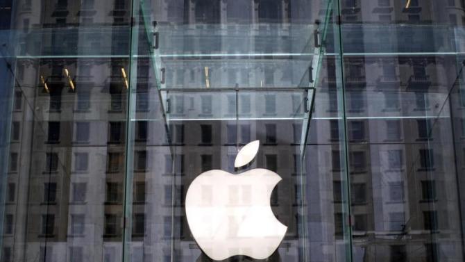 The Apple logo hangs inside the glass entrance to the Apple Store on 5th Avenue in New York City,