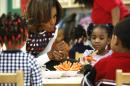 U.S. first lady Michelle Obama talks about heathy snacks with children at a La Petite Academy child care center in Bowie, Maryland