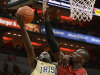 Notre Dame's Jerian Grant, left, attempts a shot over the defense of Louisville's Gorgui Dieng during the first half of an NCAA college basketball game on Saturday March 9, 2013, in Louisville, Ky. (AP Photo/Timothy D. Easley)