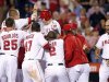 Los Angeles Angels' Mark Trumbo is mobbed at the plate by teammates after hitting a walk-off home run to defeat the New York Yankees during the ninth inning of their MLB baseball game in Anaheim