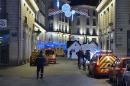 Police stand on the site where the driver of a van ploughed into a Christmas market, injuring at least ten people, before stabbing himself, in Nantes on December 22, 2014