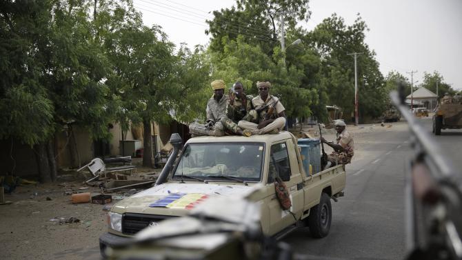Chadian soldiers ride on trucks and pickups in the city of Damasak, Nigeria, Wednesday, March 18, 2015. Damasak was flushed of Boko Haram militants last week, and is now controlled by a joint Chadian and Nigerien force. (AP Photo/Jerome Delay)
