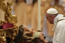 Pope Francis looks at a figurine of baby Jesus as he celebrates a mass on Christmas eve marking the birth of Jesus Christ on December 24, 2016 at St Peter's basilica in Vatican