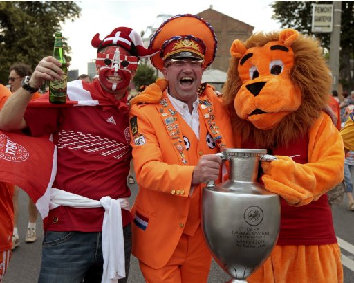 Dutch and Danish soccer fans pose for a photo as they march to the Metalist stadium for Euro 2012 match in Kharkiv