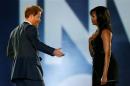 Britain's Prince Harry (L) and U.S.First Lady Michelle Obama take part in the opening ceremonies of the Invictus Games in Orlando, Florida