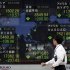 A man looks at an electronic stock board of a securities firm in Tokyo Thursday, Nov. 10, 2011 as the benchmark Nikkei 225 index fell 205.50 points, to end the morning session at 8,549.94. Setbacks in Europe's efforts to isolate a debt crisis before it blows up into an all-out recession sent Asian stock markets tumbling Thursday. (AP Photo/Hiro Komae)