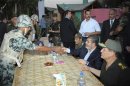 Egypt's President Mursi, Field Marshal Tantawi and Egyptian Armed Forces Chief of Staff Anan shake hands with a soldier at a checkpoint in al-Arish