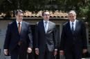 A handout picture from the Cypriot government's Press and Information Office shows Cypriot President Nicos Anastasiades (L), Turkish Cypriot President Mustafa Akinci (R) and Special Adviser to the UN Espen Barth Eide (C) on May 15, 2015