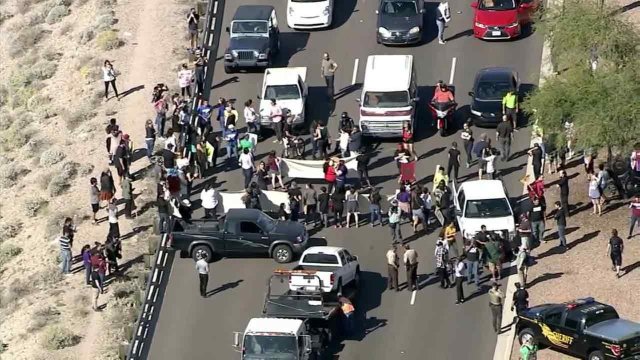 Protesters were blocking a main highway leading into the Phoenix suburb where Republican presidential front-runner Donald Trump is set to hold a campa...