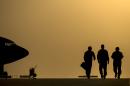 US Air Force personnel walk to their aircraft for an in-air refueling mission over Iraq, on August 11, 2014