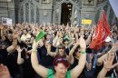 Civil service workers raise arms during protest against government austerity measures outside the Education Ministry in Madrid