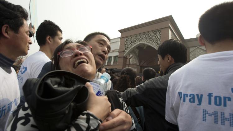 A relative of Chinese passengers on board a missing Malaysia Airlines plane breaks down as she protests outside the Malaysia Embassy in Beijing, China, Tuesday, March 25, 2014. Furious over Malaysia&#39;s handling of the lost jetliner a day after the country said the passengers must be dead, Chinese relatives of the missing marched Tuesday to the Malaysia Embassy, where they threw plastic water bottles, tried to rush the gate and chanted, &quot;Liars!&quot; (AP Photo/Ng Han Guan)