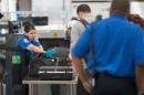 Travelers are screened by Transportation Security Administration (TSA) workers at a security check point at O'Hare Airport on June 2, 2015 in Chicago, Illinois