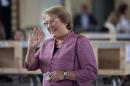 Chilean presidential candidate for the New Majority coalition Michelle Bachelet waves before casting her vote at a polling station during the general election in Santiago on November 17, 2013