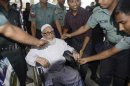 Ghulam Azam, former head of Jamaat-e-Islami party, exits a court after the verdict of his trial, in Dhaka