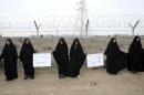 Iranian students form a human chain during a rally to defend their country's nuclear programme outside the Fordo Uranium Conversion Facility in Qom, in the north of the country, on November 19, 2013