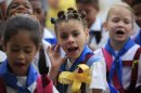 Students wearing yellow ribbons sing during a ceremony commemorating the 15th anniversary of the arrest of five Cuban agents in the U.S. at the start of their school day in Havana, Cuba, Thursday, Sept. 12, 2013. Rene Gonzalez, one of the five who was freed in 2011, called for people to wear and hang yellow ribbons to press for the release of the four others still in U.S. prisons who were convicted of spying. (AP Photo/Franklin Reyes)