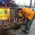 Phil Furtado places candles on a burned city bus bench in Los Angeles on Thursday, Dec. 27,2012. Police arrested a man for allegedly setting a 67-year-old woman on fire who was sleeping on the bus stop bench.  A witness said he saw a man come out of the store and pour something on the woman who had been sleeping on a bench before striking a match and setting her ablaze. The woman, who may be homeless, was taken to a hospital and listed in critical condition. (AP Photo/Greg Risling)