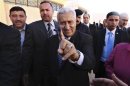 Jordanian Prime Minister Abdullah Ensour shows his ink-stained finger after casting his vote at a polling station in Al Salt