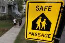 Woman walks children to Sherwood Elementary School along the Safe Passage route in the Englewood neighborhood in Chicago, Illinois, United States