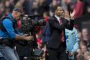 Manchester United's interim manager Ryan Giggs applauds supporters after his team's 4-0 win against Norwich City in their English Premier League soccer match at Old Trafford Stadium, Manchester, England, Saturday April 26, 2014. (AP Photo/Jon Super)