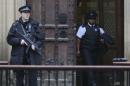 An armed police officer stands outside the Houses of Parliament, central London