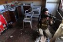 File photo of a fighter from the Sadik unit of Free Syrian Army's Tahrir al Sham brigade firing his Steyr AUG rifle from inside a house during heavy fighting in Mleha suburb of Damascus