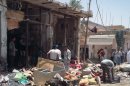Iraqis inspect the damage following a car bombing in Zubaidiyah