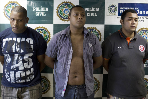 <p> Suspects Wallace Aparecido Souza Silva, left, Carlos Armando Costa dos Santos, center, and Jonathan Foudakis de Souza are presented to the press at the Special Police Unit for Tourism Support (DEAT) after being arrested for allegedly attacking tourists in Rio de Janeiro, Brazil, Tuesday, April 2, 2013. An American woman was gang raped and beaten aboard a public transport van while her French boyfriend was shackled, hit with a crowbar and forced to watch the attacks after the pair boarded the vehicle in Rio de Janeiro's showcase Copacabana beach neighborhood, police said. The attacks took place over six hours starting shortly after midnight on Saturday. (AP Photo/Felipe Dana)