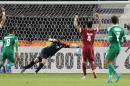 Qatar's goalkeeper Muhannad Naim (C) tries to save a shot during their AFC U23 Championship 3rd place football match between Qatar and Iraq in Doha on January 29, 2016