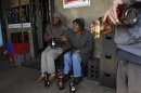 Men chat as they drink beer at a sheeben in Soweto, southwest of Johannesburg