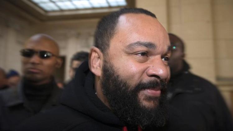 Controversial French comedian Dieudonne arrives at court in Paris on December 13, 2013 to face charges of defamation, insult and incentive to hate and discrimination