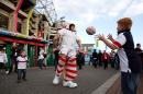 Children play with a rugby ball with costumed entertainers outside Twickenham stadium on September 26, 2015