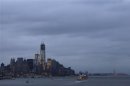 Gray skies hover over the skyline of New York's Lower Manhattan as a cruise ship sails from its port on the Hudson River as seen from Weehawken, New Jersey