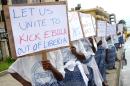 Women of the group "Peace Mothers" hold placards to raise awareness for the Ebola epidemic in central Monrovia on September 1, 2014